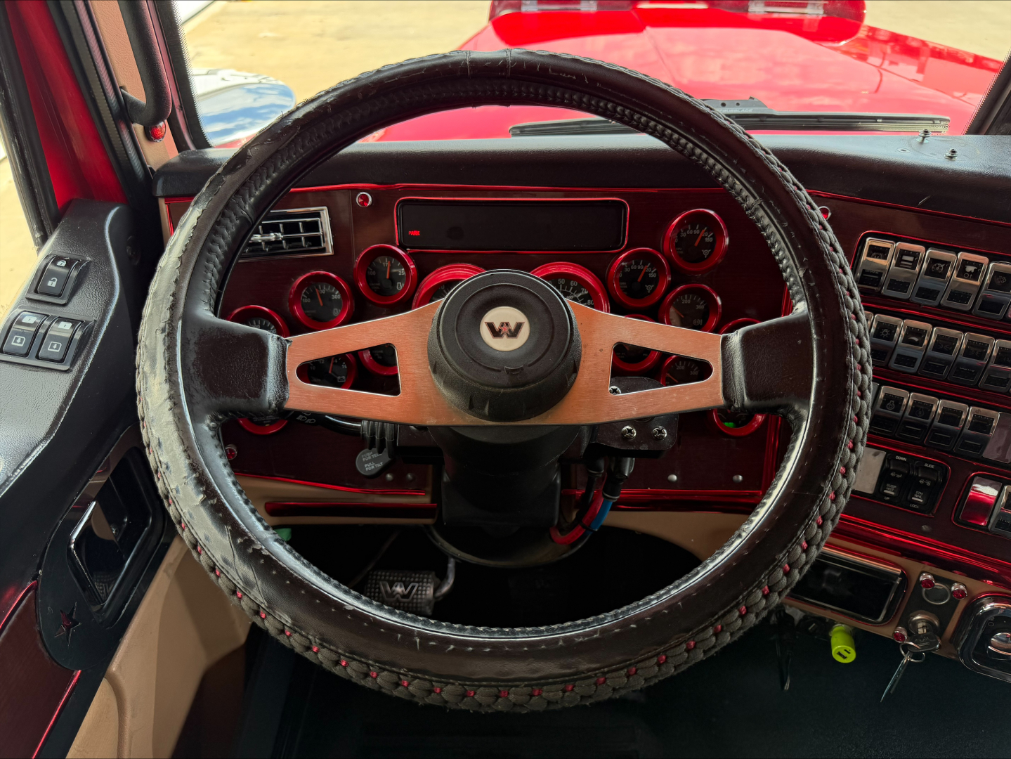 Interior view of a 2020 Western Star 4900 truck dashboard and steering wheel with multiple gauges and controls.