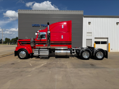 Western Star 4900 conventional sleeper truck side view showing red cab and rear axle configuration.