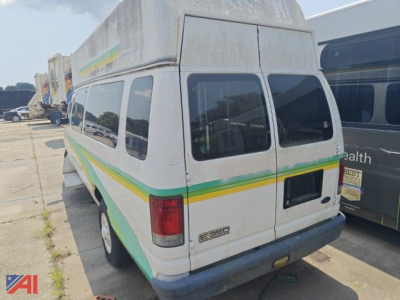 Ford E-350 van rear view showing cargo van, white with green and yellow stripe, dual rear doors, 2008 model year, back hatch and taillights visible.