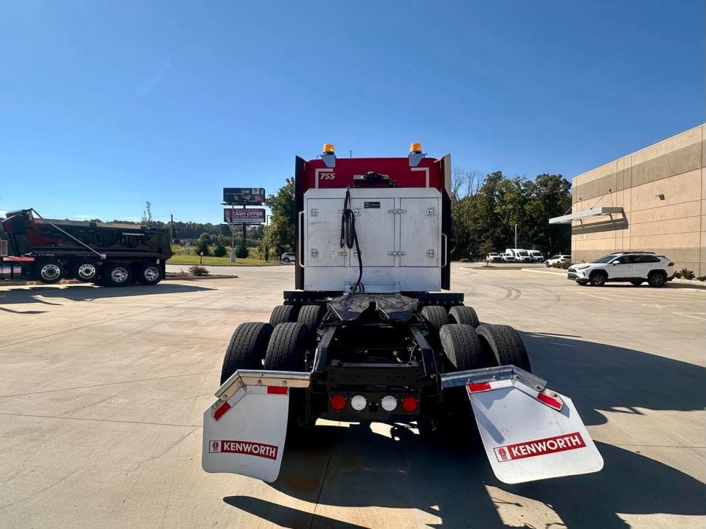 Kenworth T680 rear view showing fifth-wheel and dual rear axles with Kenworth mud flaps.