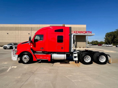 Kenworth T680 conventional sleeper tractor in red, side view showing cab and dual rear axles.