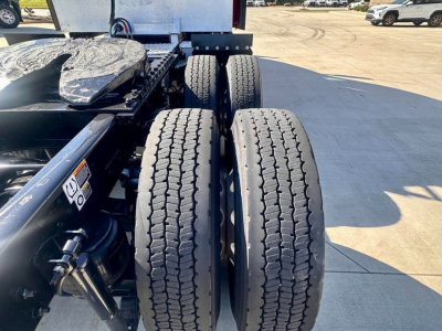 Kenworth T680 rear dual tires and tractor frame showing wheel axles and suspension.