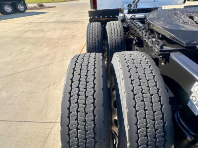 Kenworth T680 truck rear dual tires and chassis view showing tandem axle and wheel rims.