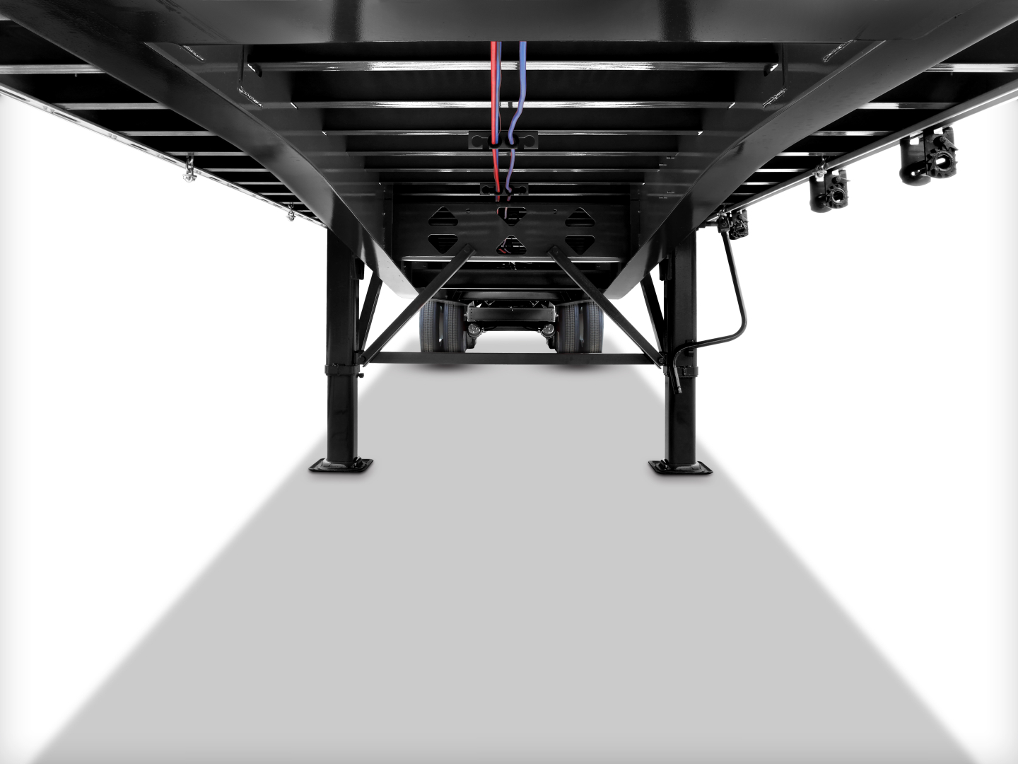 Underbody view of a Fontaine 53' combo flatbed trailer showing tandem rear axle area with structural frame and wiring harnesses.