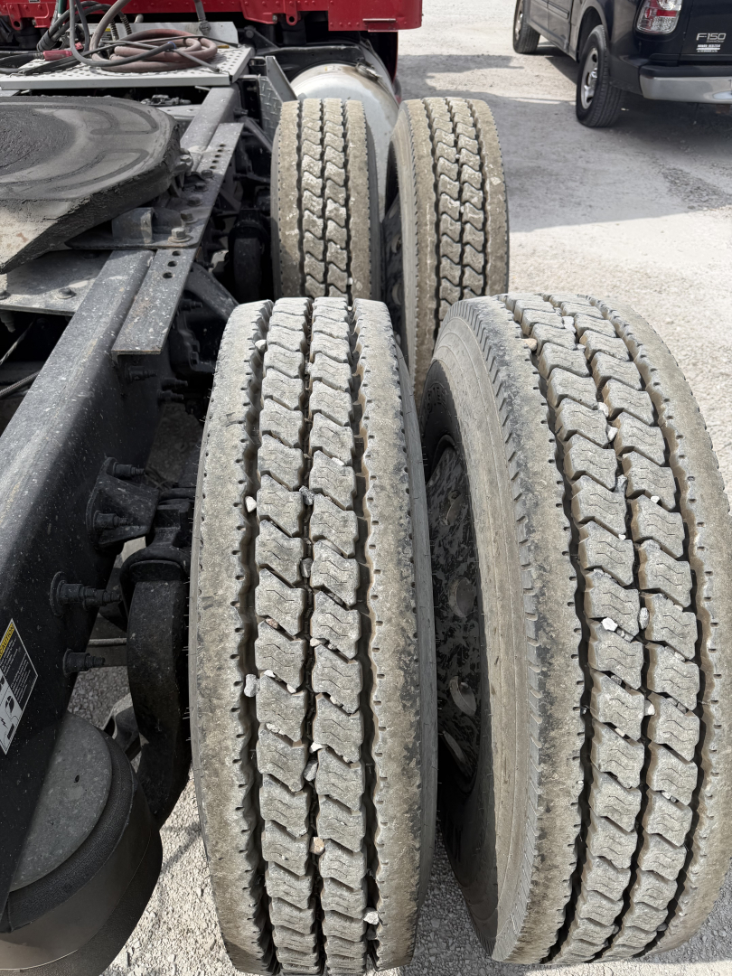 Peterbilt 579 truck chassis showing rear duals with treaded tires and visible suspension components.