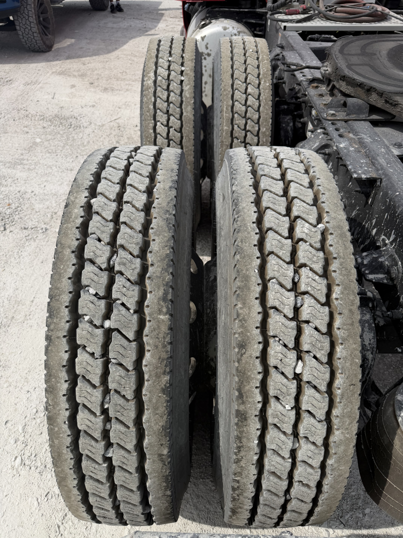 Rear dual-axle truck tires with tread patterns visible, part of a Peterbilt 579 chassis.