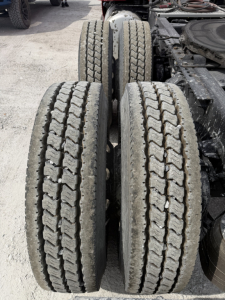 Rear dual-axle truck tires with tread patterns visible, part of a Peterbilt 579 chassis.