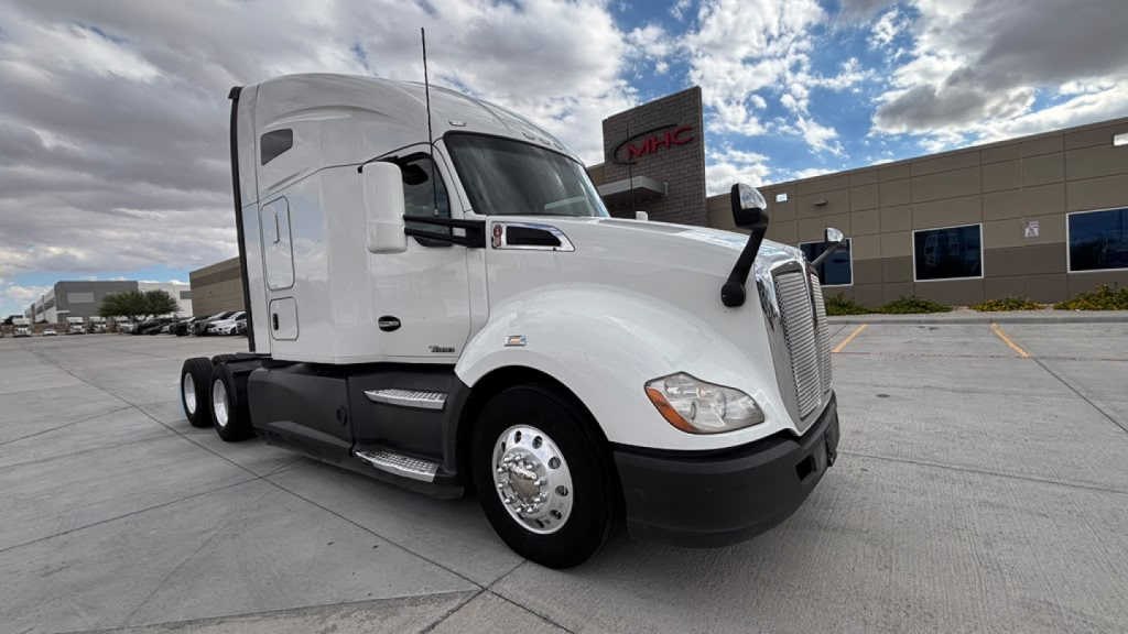 2021 Kenworth T680 or similar white sleeper cab truck with large grille, side mirrors, and Kenworth styling. Visible text includes no explicit brand markings legible in image.