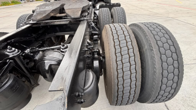 Kenworth T680 chassis and dual rear axles showing wheels, suspension, and drivetrain components in view.
