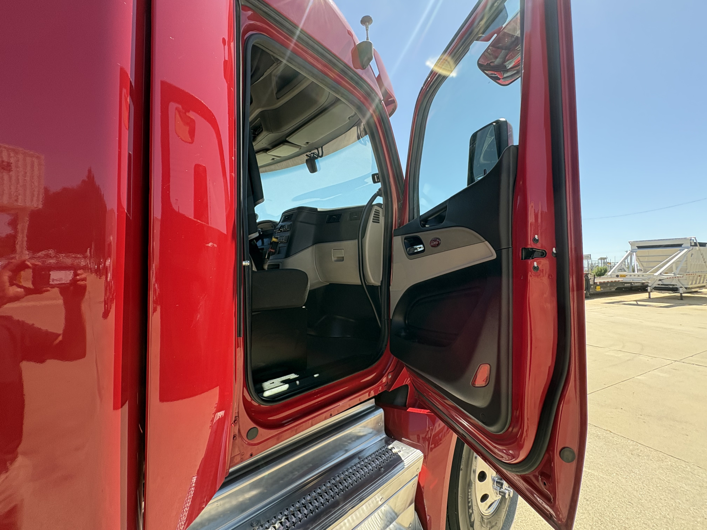 Peterbilt 579 truck cab entry door open showing interior driver seat and dashboard area.