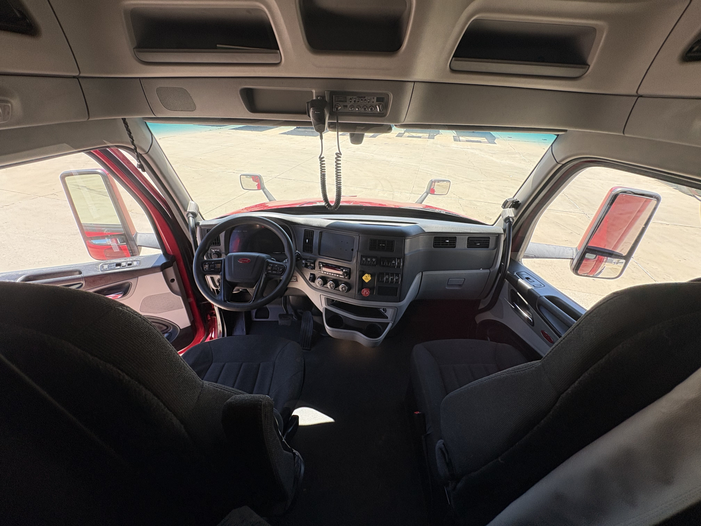 Peterbilt 579 dashboard and interior view showing steering wheel and center console.