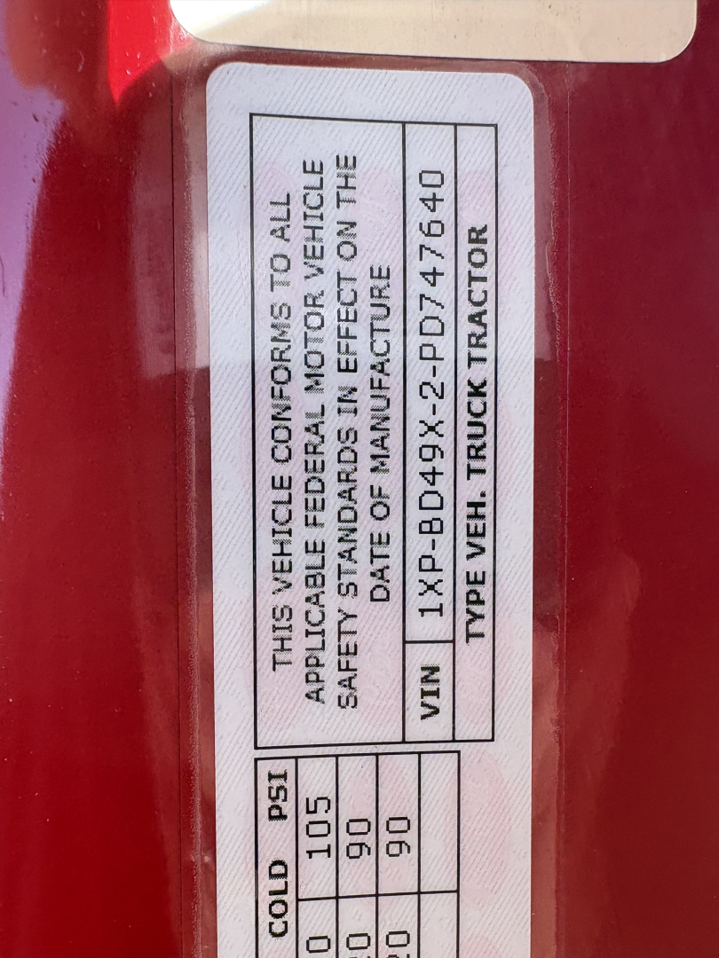Vehicle compliance label on a Peterbilt 579 door jamb showing VIN 1XPBD49X2PD747640 and date of manufacture.