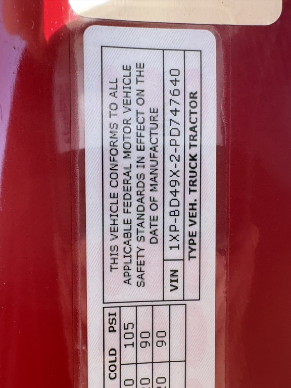 Vehicle compliance label on a Peterbilt 579 door jamb showing VIN 1XPBD49X2PD747640 and date of manufacture.