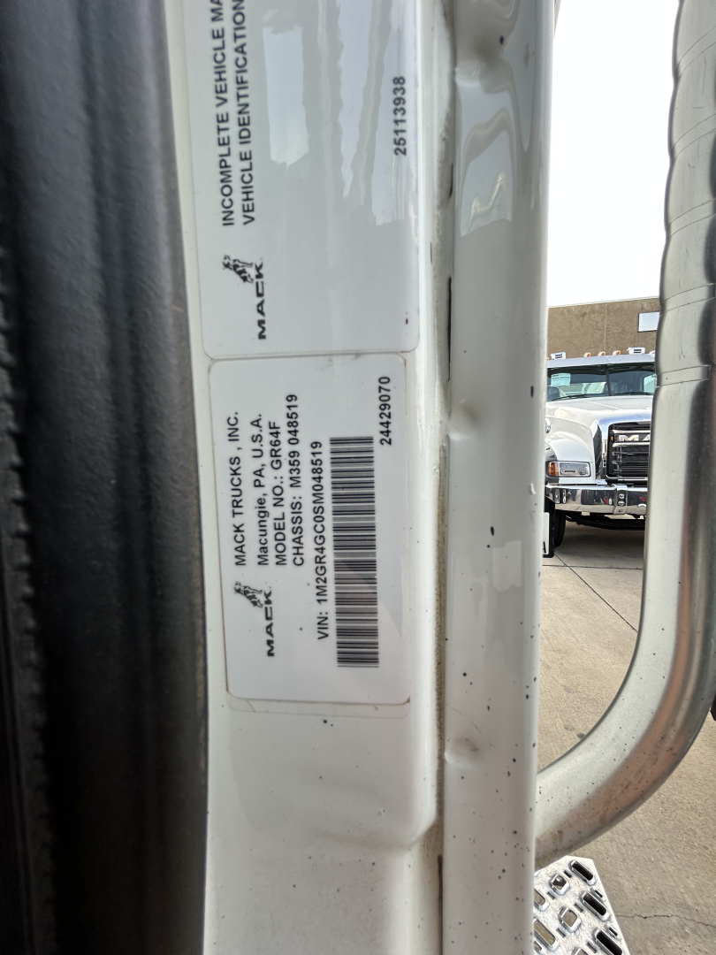 Label on Mack GR64F door jamb showing VIN and stock numbers. Text includes MACK TRUCKS INC., MACK TRUCKS, INC., VEHICLE IDENTIFICATION NUMBER, VIN 1M2GR4GC0SM048519, STOCK NO. B3421P, MACK TRUCKS INC. PRODUCTION/IDENTIFICATION INFORMATION, 