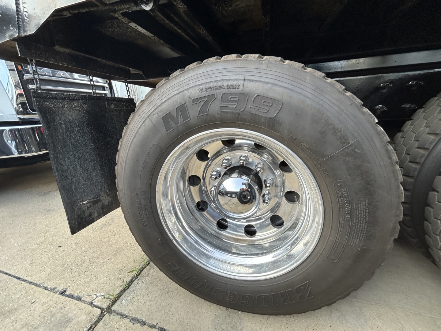 Mack GR64F wheel and tire showing M7993 on sidewall and polished chrome rim
