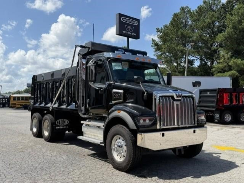 Western Star 47X dump truck in black with chrome grille, dump bed, and dual rear wheels, VIN 3BJHBPDV8VDXF6245 visible on listing signage.