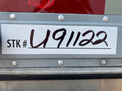Trailer rear showing STK # U91122 and VIN 1UYVS2535M2382648 plate with used status.