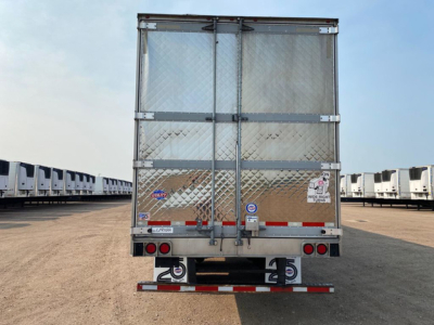 Rear view of a used 2021 Utility refrigerated trailer showing doors with metal Diamond plate lower panels and rear step bumper.