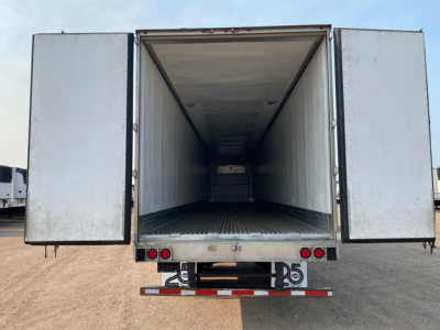 Trailer cargo area of a 2021 Utility Reefer showing open rear doors with empty interior and metal floor.