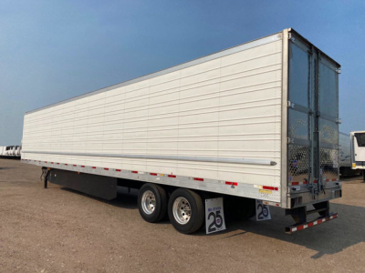Trailer side and rear showing 2021 Utility reefer trailer with tandem axles and closed rear doors.