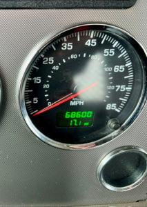 Speedometer gauge showing 0-85 mph with odometer reading 68600 and 171 miles trip; interior panel in view