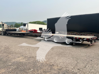 Manac steel drop extendable trailer shown in side view with black gooseneck and multiple axles, chain hookups, and flatbed sections.