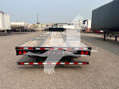 Manac steel drop extendable trailer rear view showing taillights and reflective red/white markings with 'MANAC' logo on the rear edge.