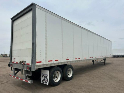 Trailer side view showing a 2016 Wabash box trailer with dual rear wheels and reflective tape along the lower side.