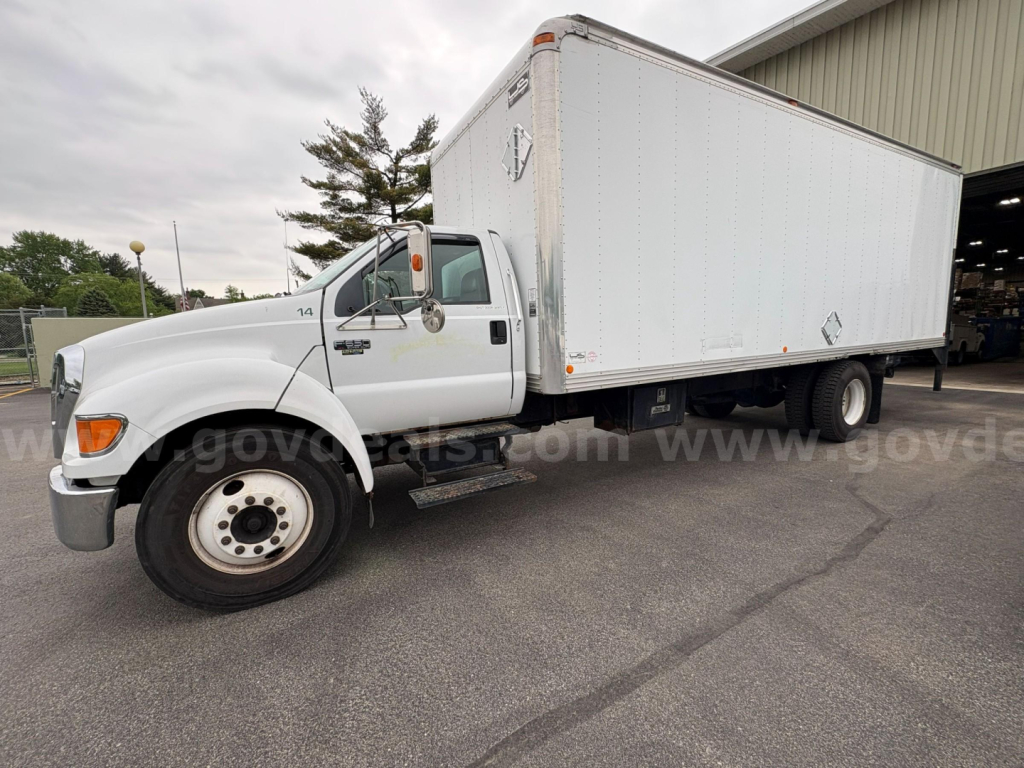 Box truck side view showing 2004 Ford F-650 with a large white cargo box and dual rear wheels.