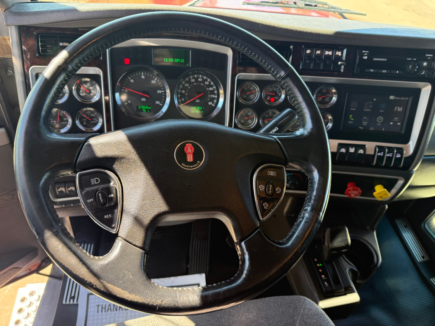 Kenworth W900L interior dashboard and steering wheel with gauges and controls visible