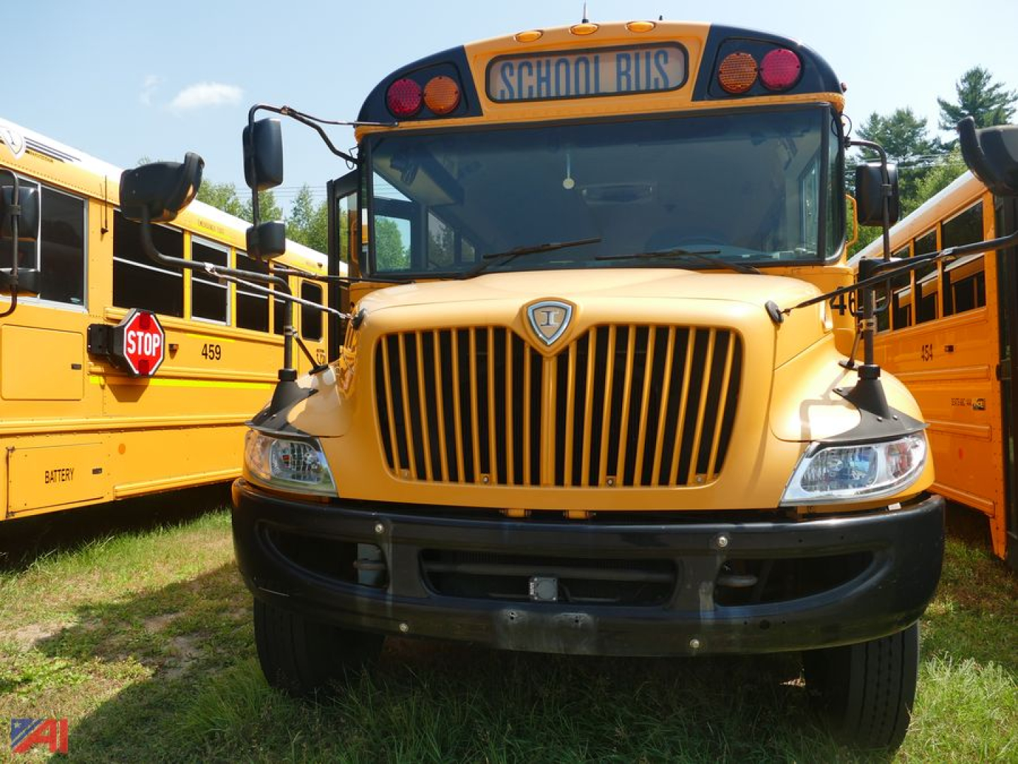 Front view of a yellow 2019 International CE 3000 school bus with a black bumper, large grille, stop sign on left side, and 'SCHOOL BUS' sign on top of windshield.