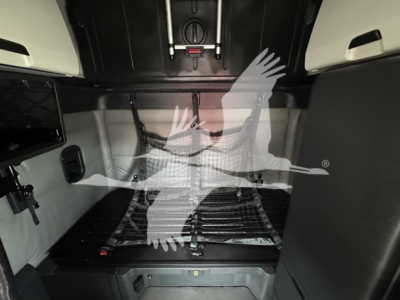 Freightliner Cascadia 126 sleeper cab interior cargo area with storage nets and anchor points.