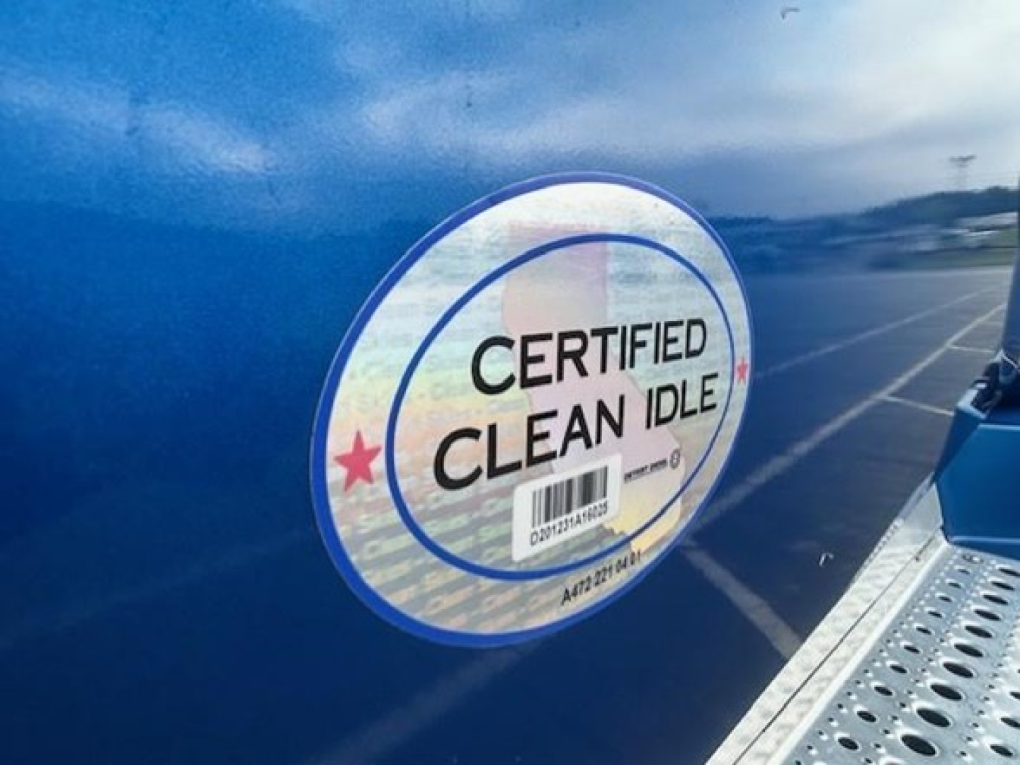 Freightliner Cascadia 126 door sticker showing Certified Clean Idle label on blue exterior.