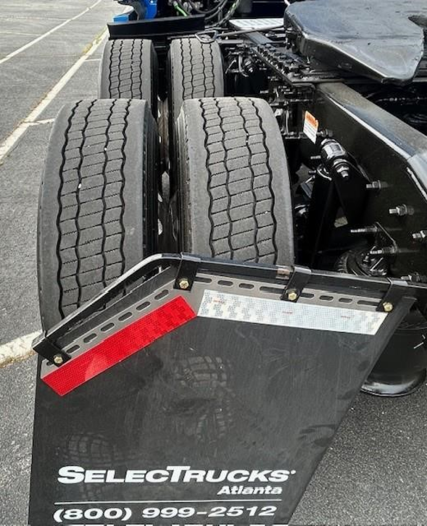 Truck view of a 2022 Freightliner Cascadia 126 showing dual rear axles and a SelectTrucks Atlanta plate with contact number.