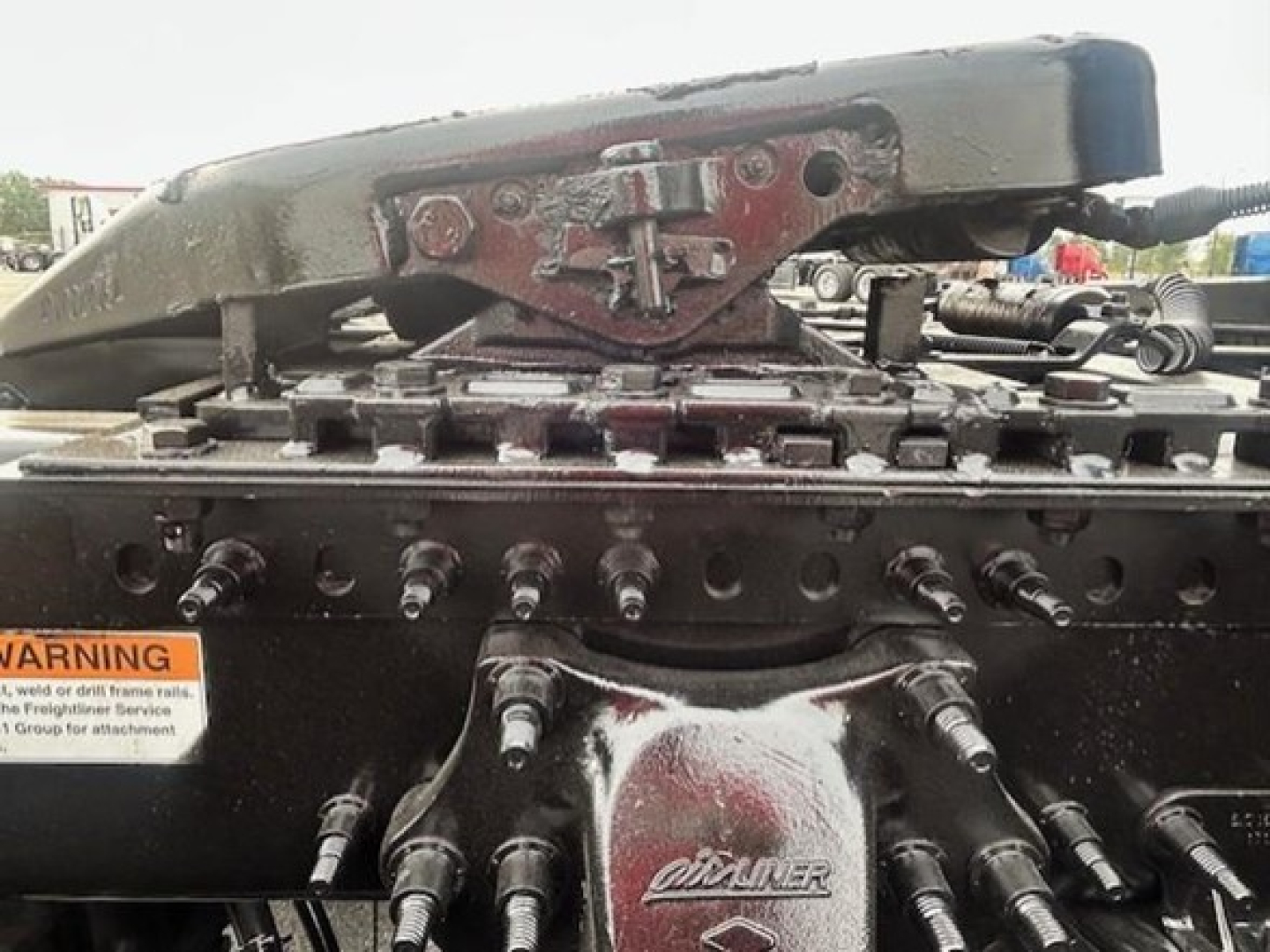 Truck cab and air lines with mounting hardware and warning label visible