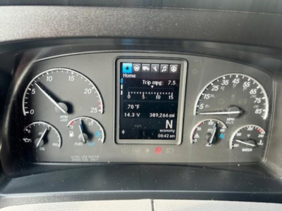 Dashboard view of a Freightliner Cascadia 126 showing instrument cluster, center multi-function display, and gauge needles.