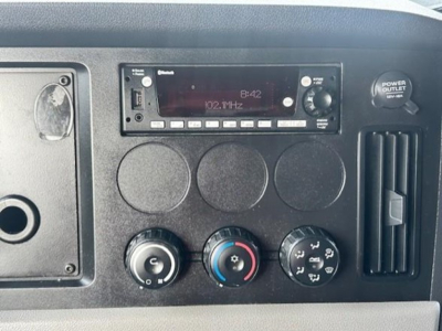 Dashboard panel of a 2022 Freightliner Cascadia 126 showing radio display and climate controls.