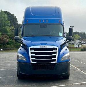 Freightliner Cascadia 126 front view in blue with large grille and sleeper cab.