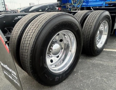 Freightliner Cascadia 126 truck rear dual wheels with Bridgestone tires and polished chrome rims.