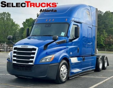 Freightliner Cascadia 126 truck in blue from front-left angle with SelecTrucks Atlanta logo.