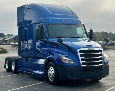 Freightliner Cascadia 126 sleeper tractor in blue, side view showing cab with aerodynamic mirrors and chrome grille.