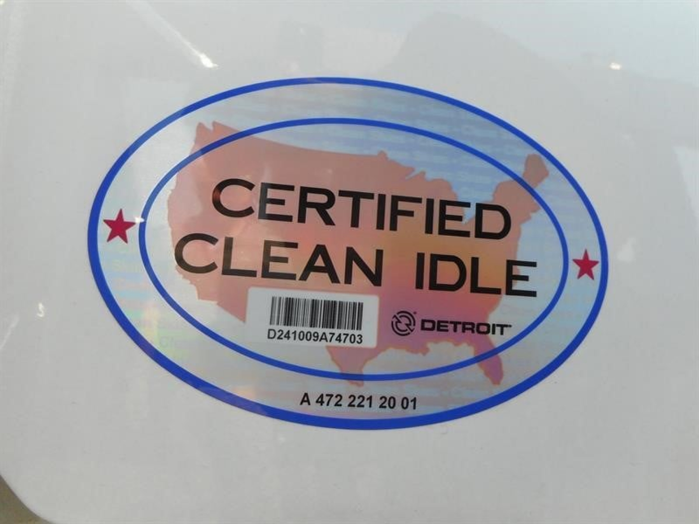 Certified Clean Idle sticker on white surface showing blue oval border and map graphic with D Detroit logo and barcode.