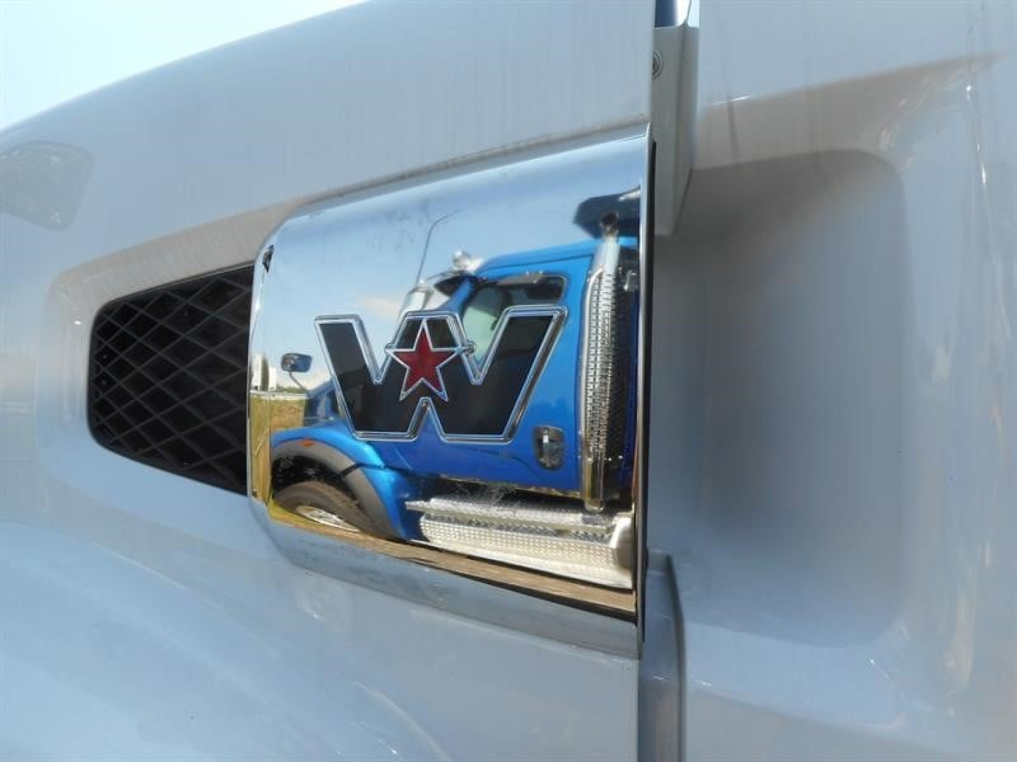 Western Star 49X truck hood emblem reflection on chrome grille showing blue star logo