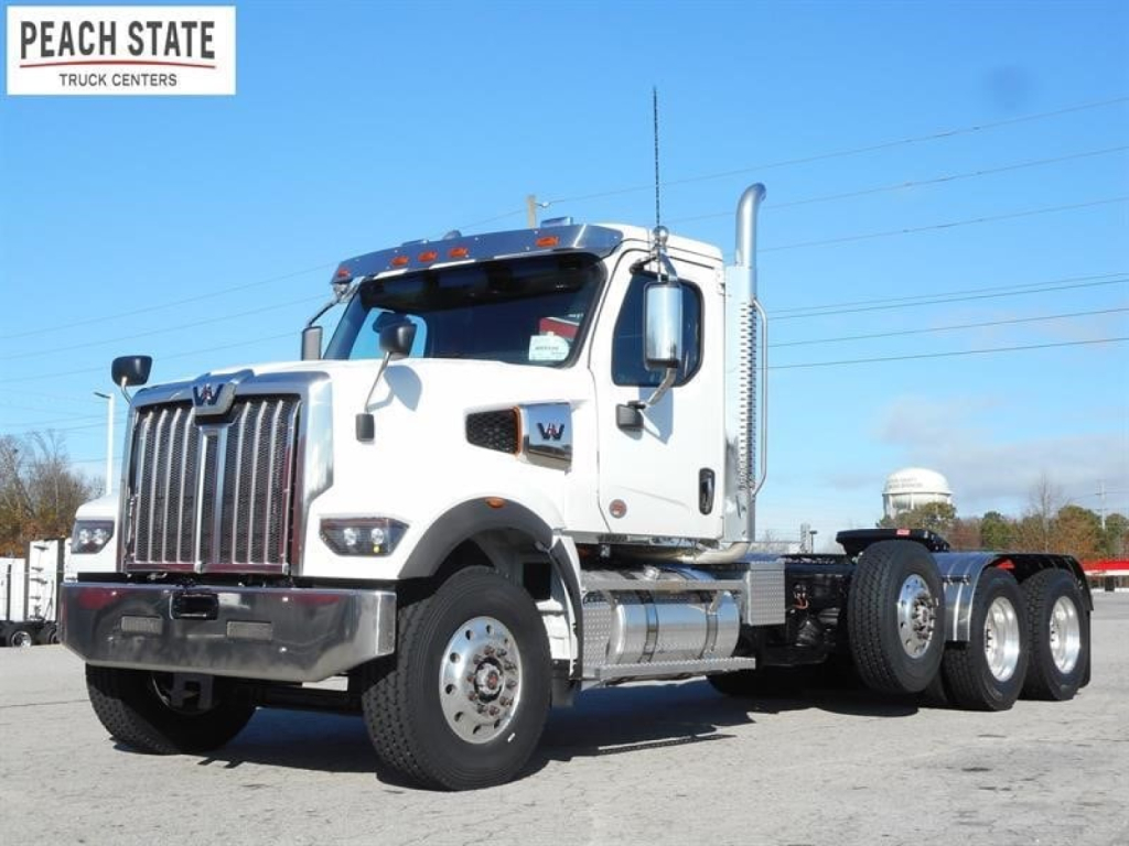 Western Star 49X day cab truck in white, front view with chrome grille and dual rear axles, Peach State Truck Centers logo in top left.