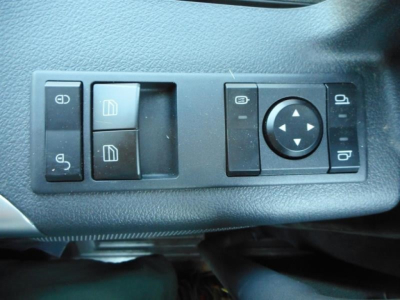 Side of Western Star 49X interior door panel showing window and mirror control switches.