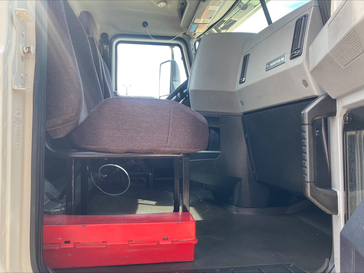 Mack AN42T truck cabin interior showing driver seat and dashboard area with steering column and control panels.