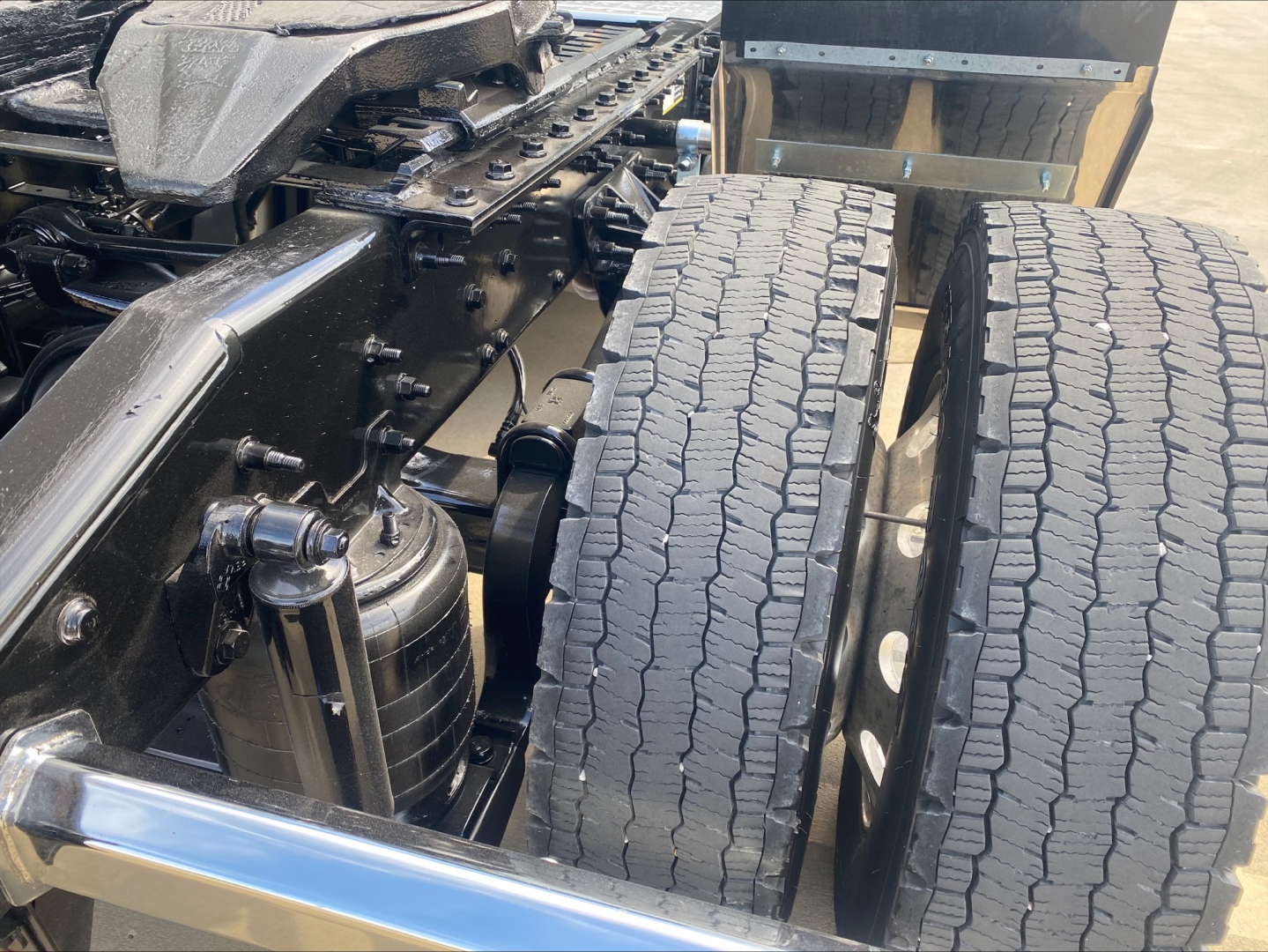 Mack AN42T truck chassis showing dual rear tires and engine bay with air filter canister and frame rails.