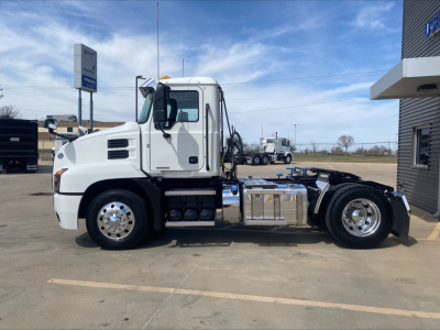 Truck side profile of a white 2021 Mack AN42T daycab with dual rear axles, chrome fuel tanks, and accessible engine compartment; VIN 1M1AN4AY3MM002194 visible.