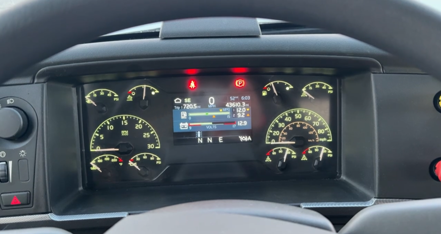 Dashboard display of a Volvo VNR300 day cab showing instrument cluster with multiple gauges and a central digital readout.