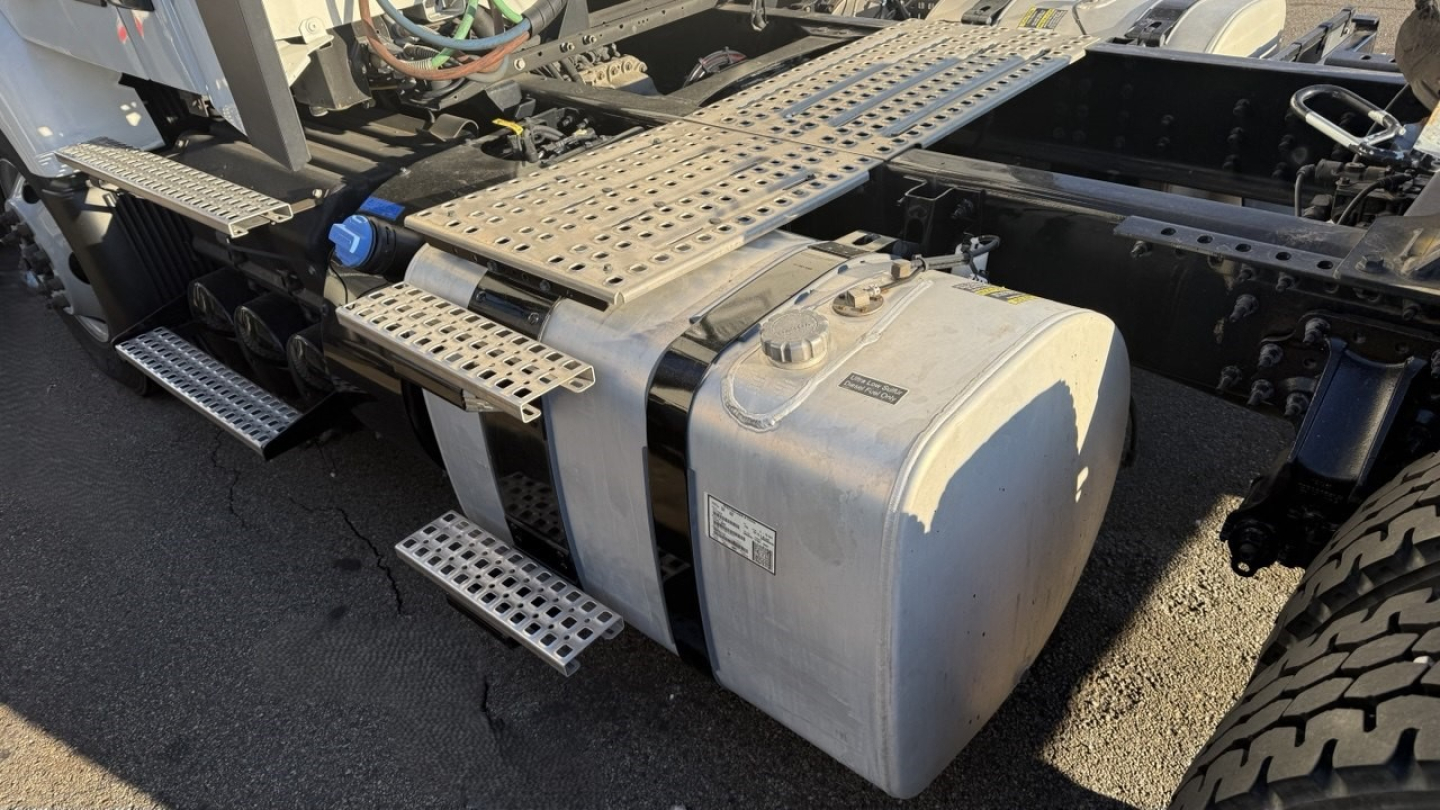 Fuel tank and chassis area of a 2022 Volvo VNR300 4x2 day cab showing large aluminum fuel/def tank with side steps and metallic frame components